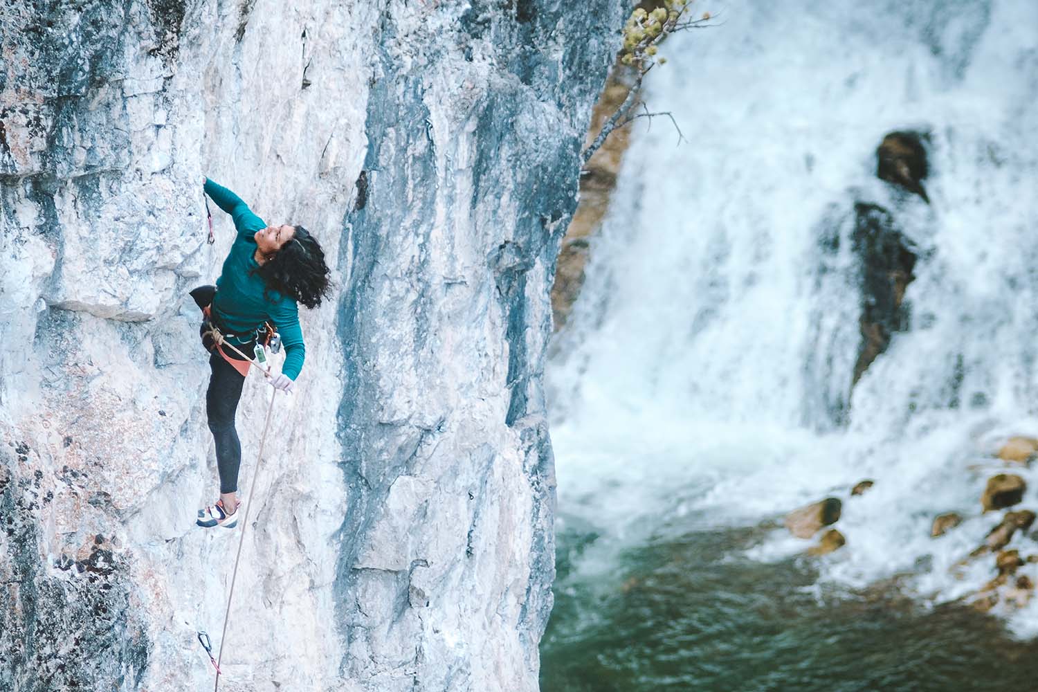 A woman climbing in Montana merino.