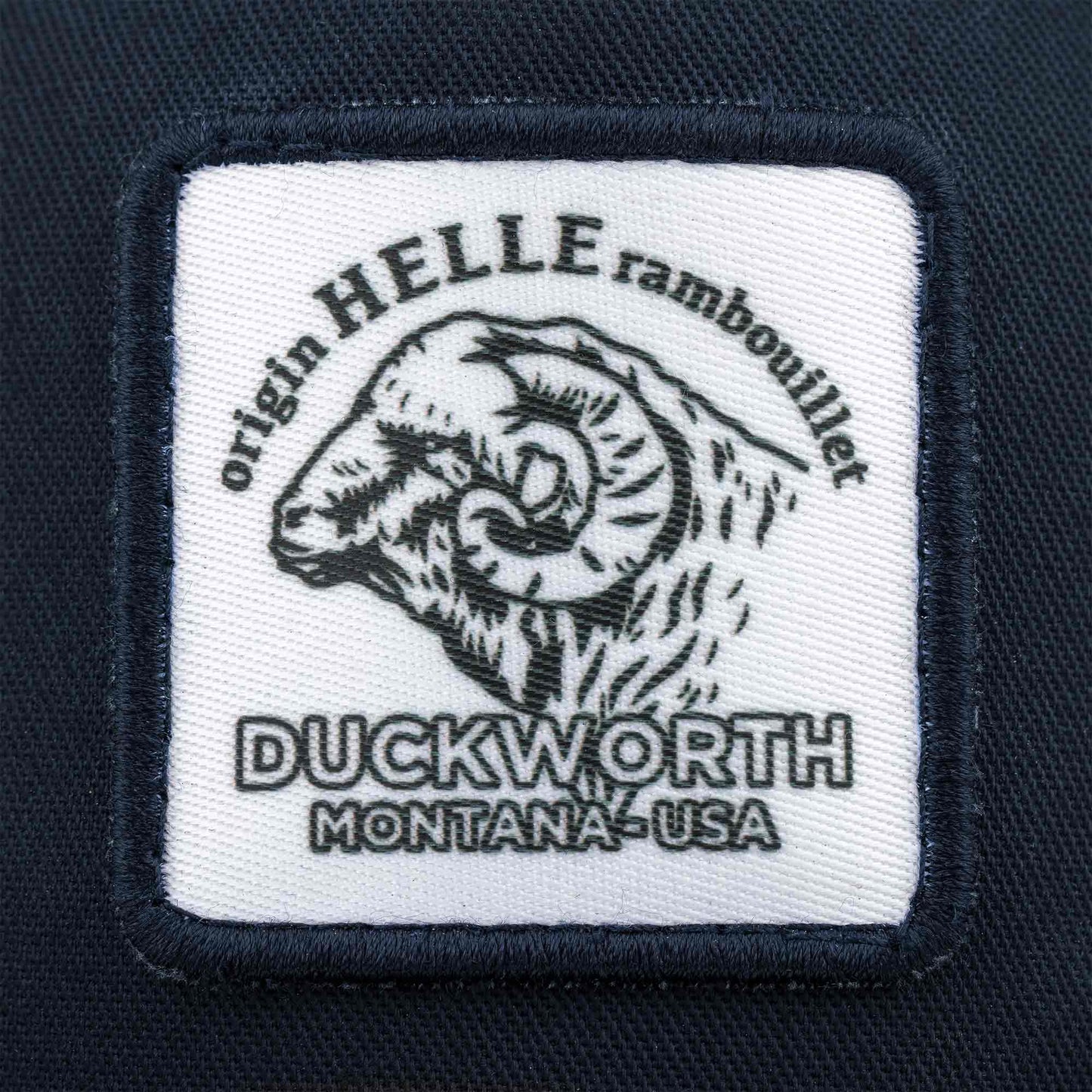 A blue American made trucker hat with a Duckworth patch on it.