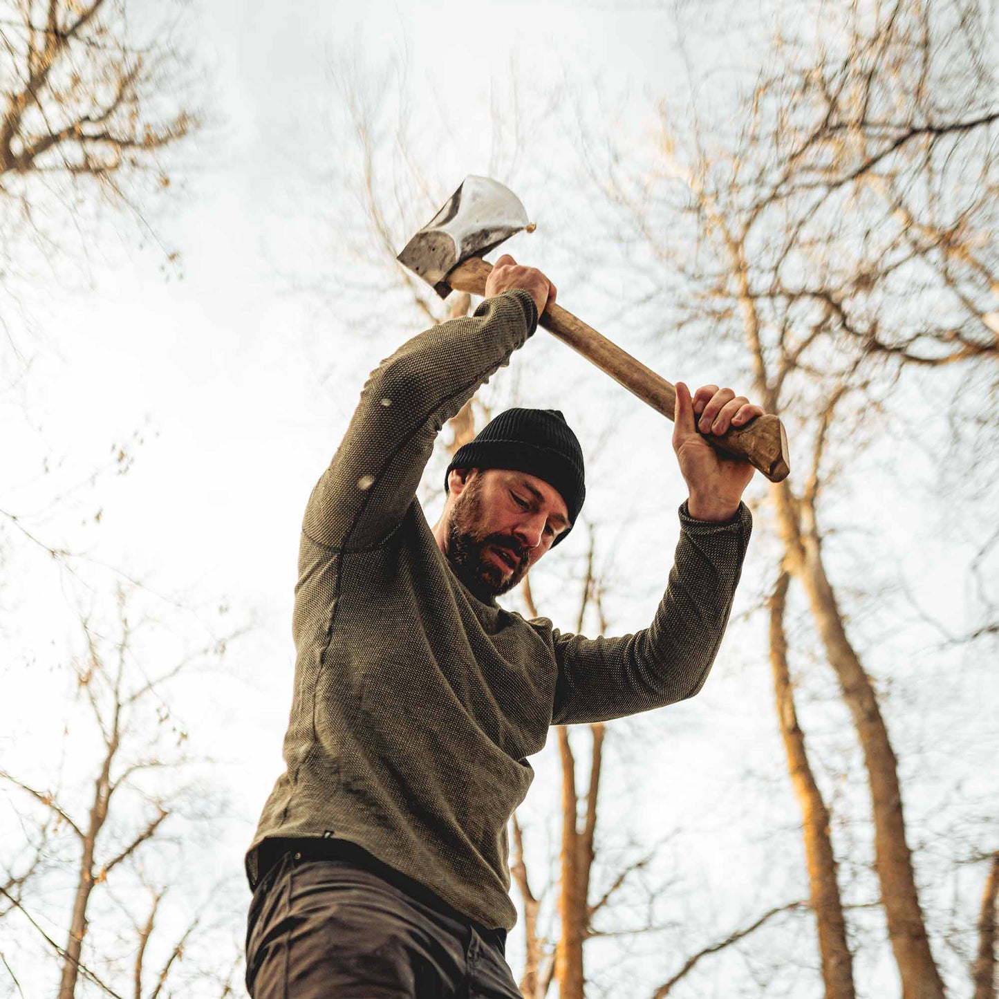 A man wearing a green American made Duckworth merino wool waffle knit long sleeve henley. 