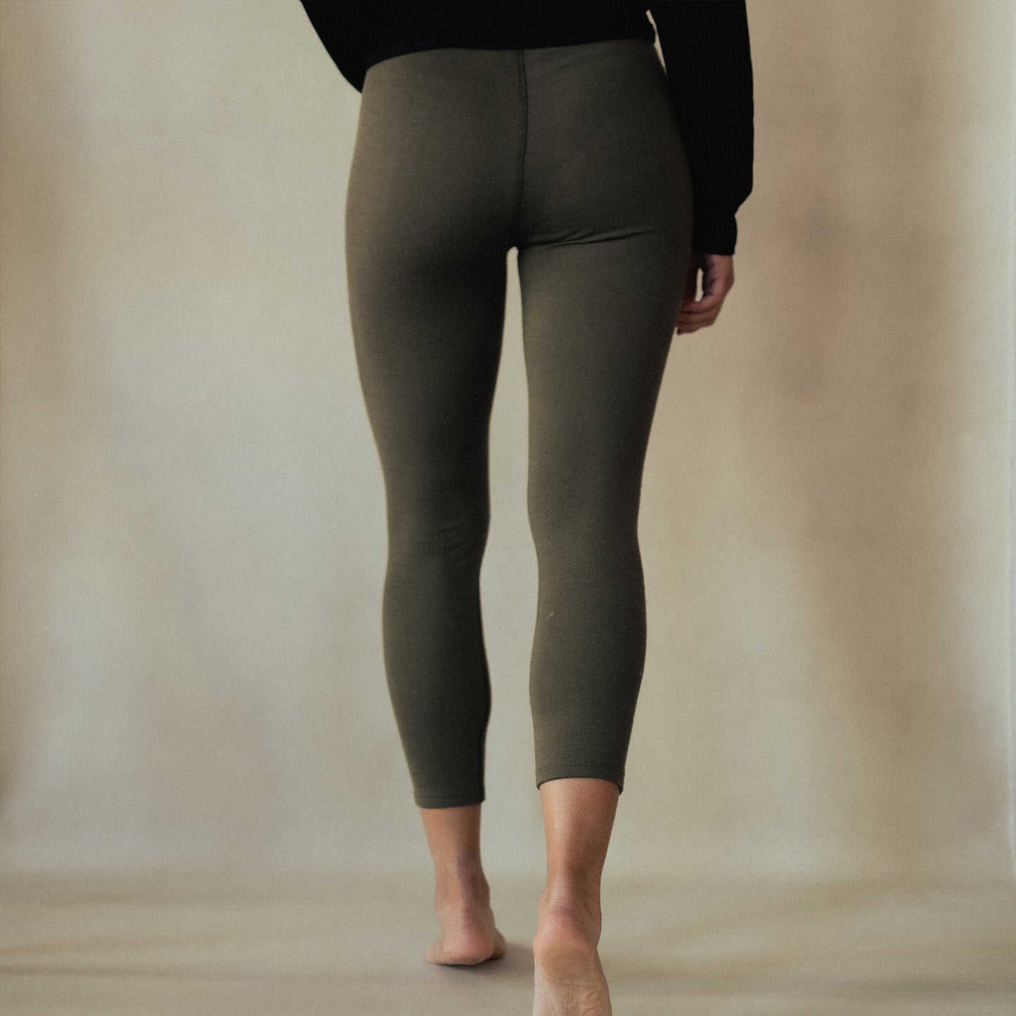 A woman wearing green American made Duckworth merino wool legging.