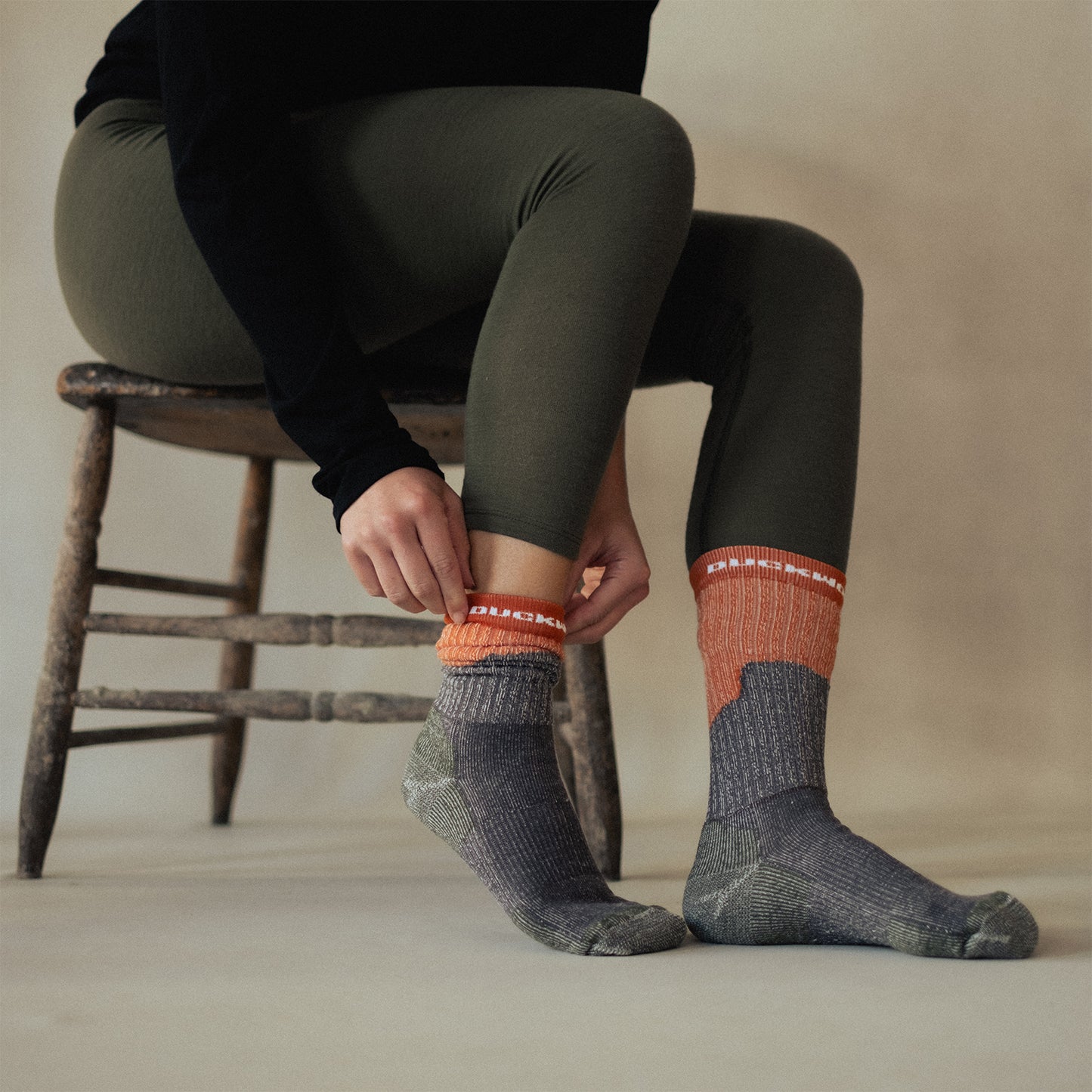 A woman wearing green American made Duckworth merino wool legging.