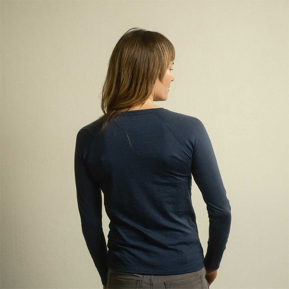 A woman wearing an American made Duckworth merino wool long sleeve base layer.