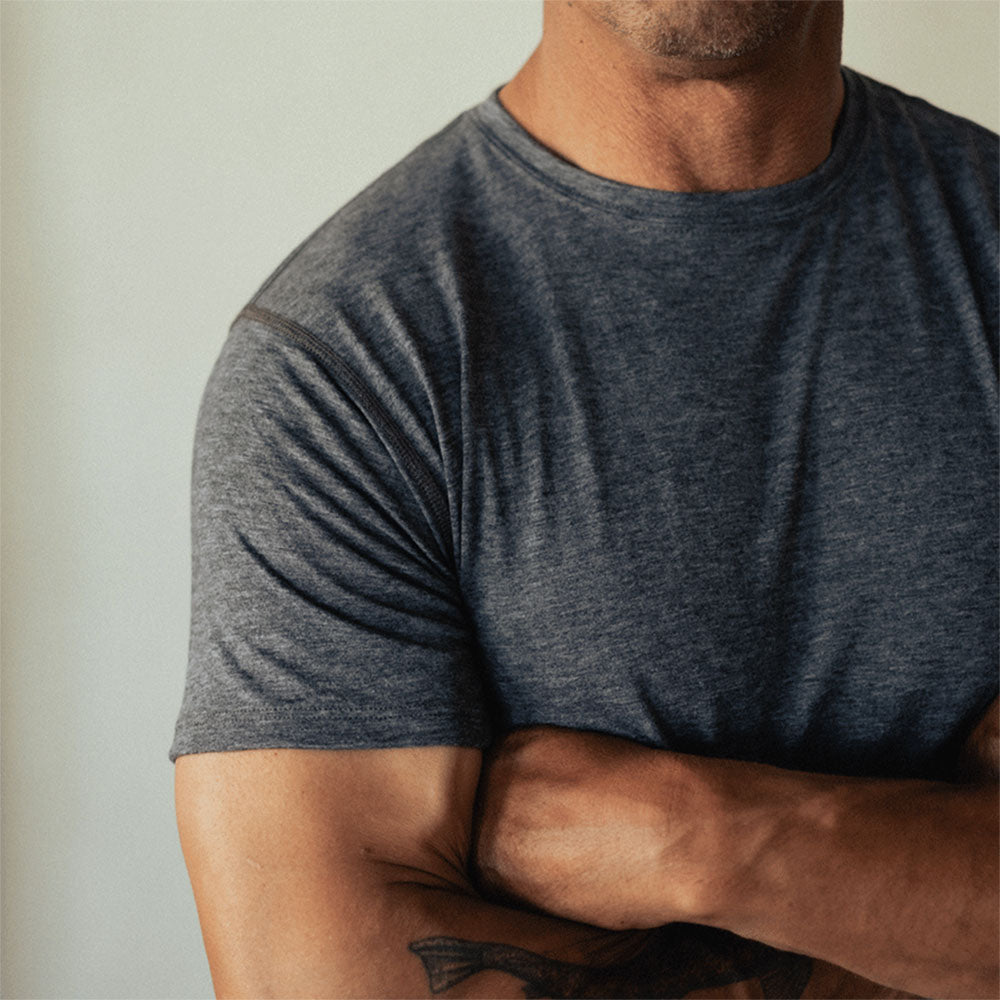 A man wearing a gray American made Duckworth merino wool light weight tee shirt.