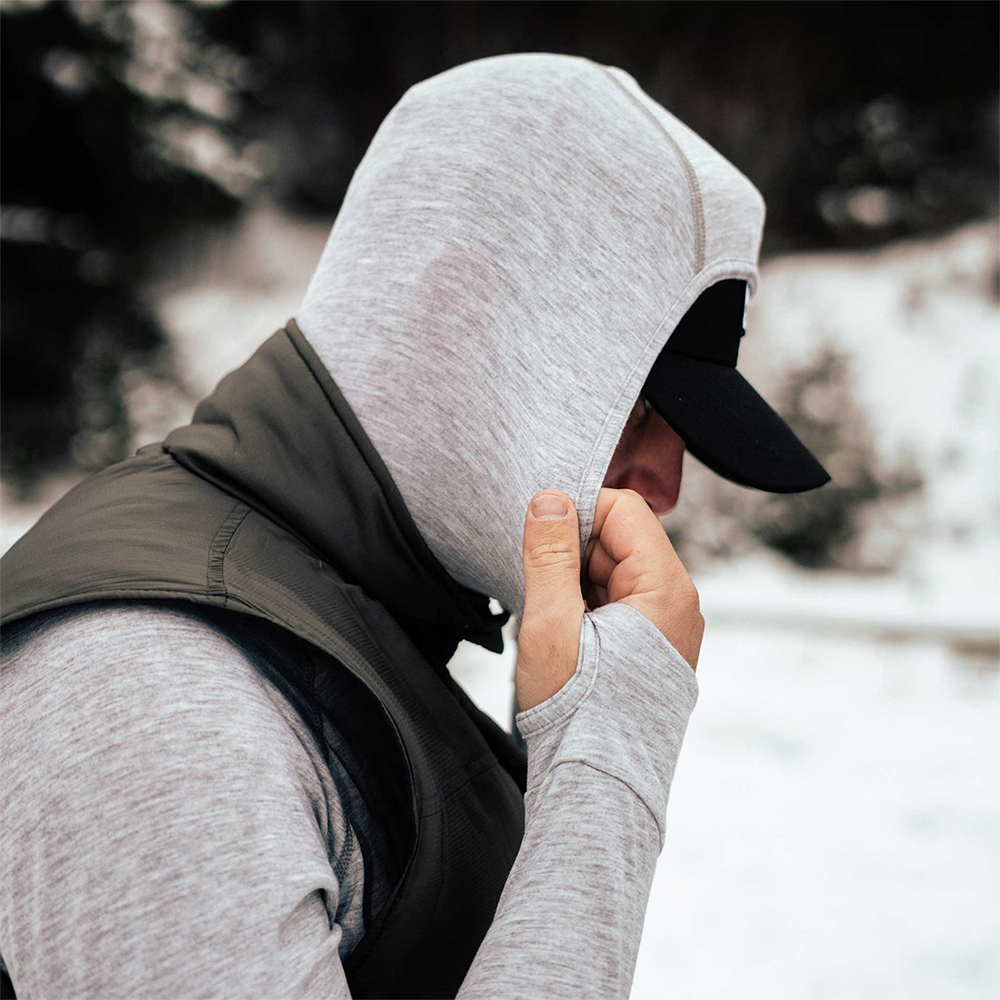 A man wearing a gray American made Duckworth merino wool exercise hoody.