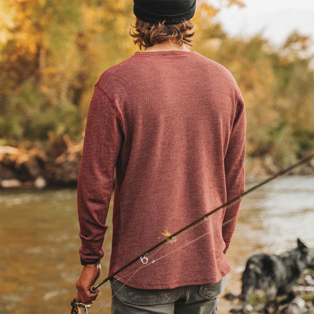 A man wearing a red American made Duckworth merino wool waffle knit long sleeve. 