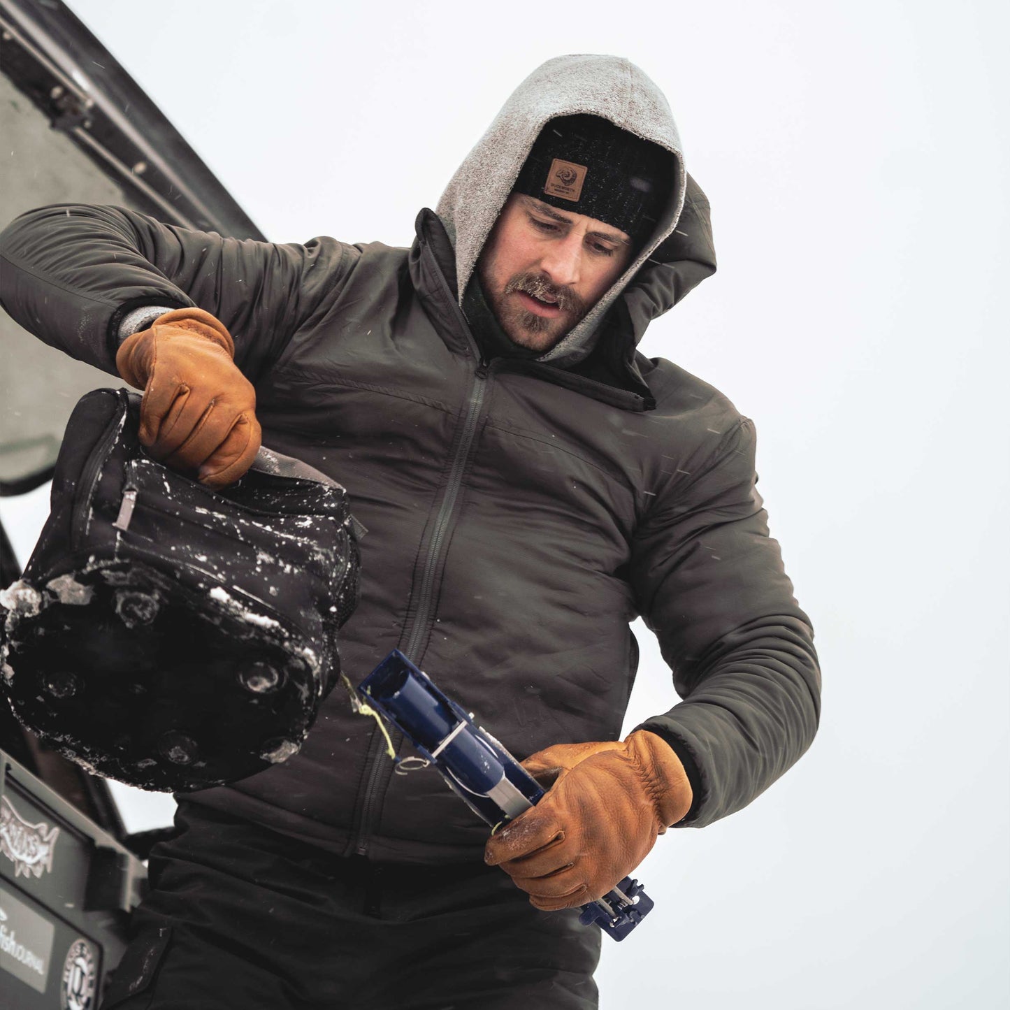 A man wearing a gray American made Duckworth soft shell wool insulated jacket.