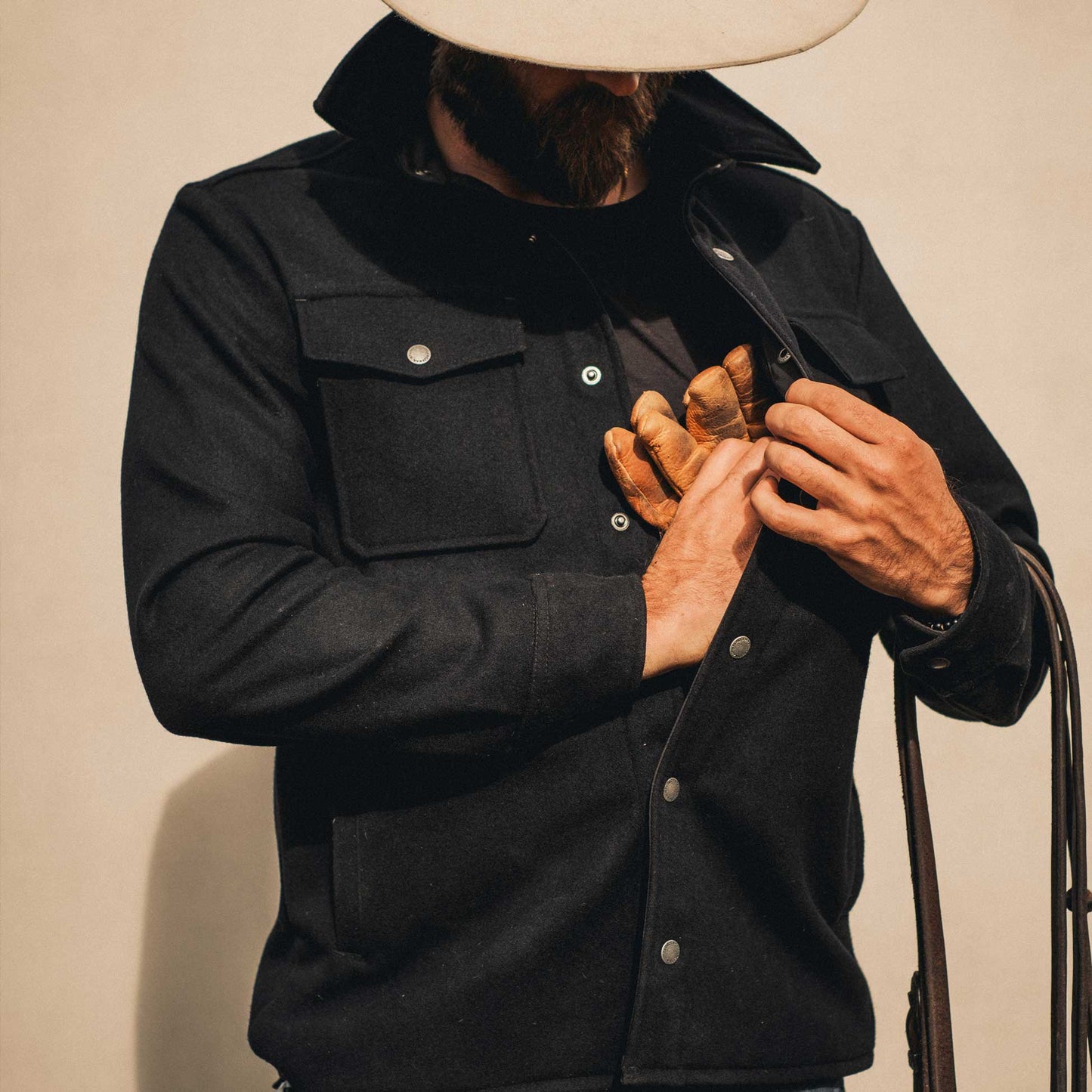 A cowboy wearing black American made Duckworth merino wool shirt jacket.