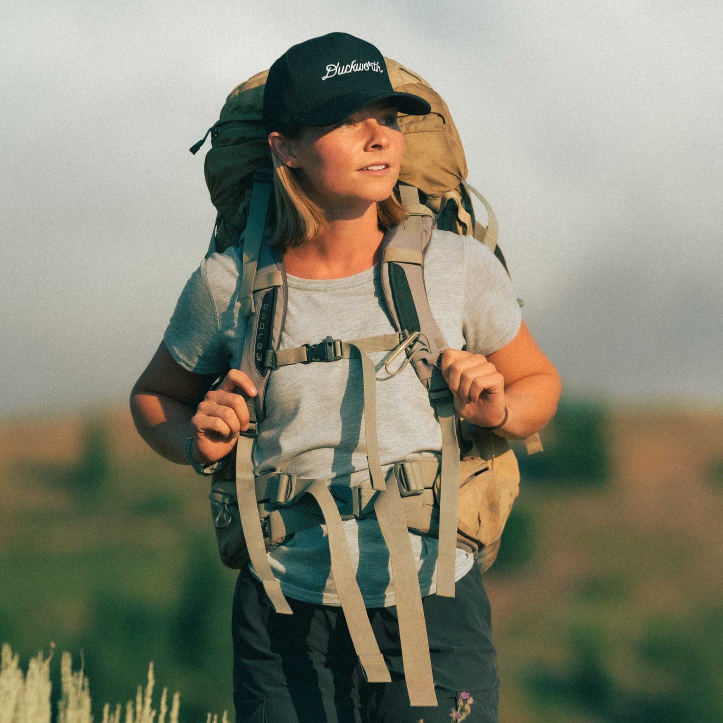 A hiker wearing a gray American made Duckworth merino wool performance tee shirt.