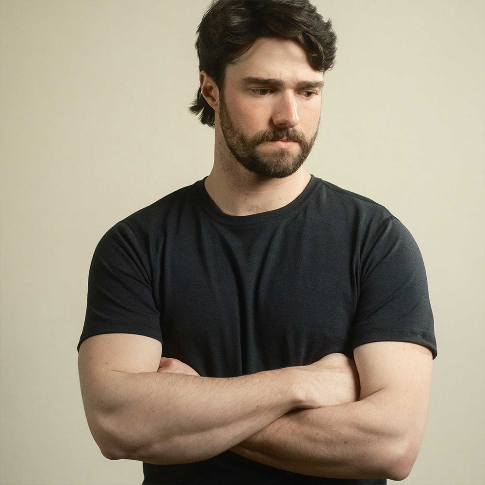 A man wearing a black American made Duckworth merino wool tee shirt. 