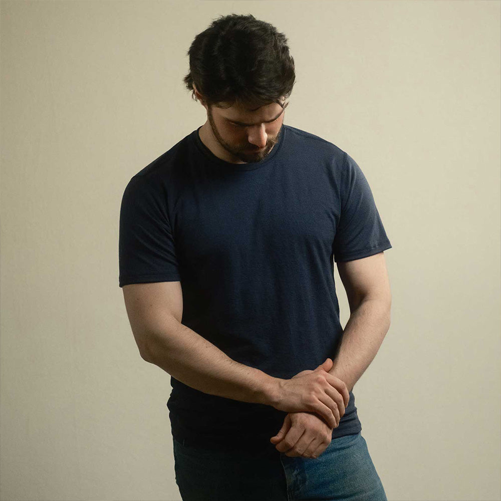 A man wearing a navy American made Duckworth merino wool tee shirt. 