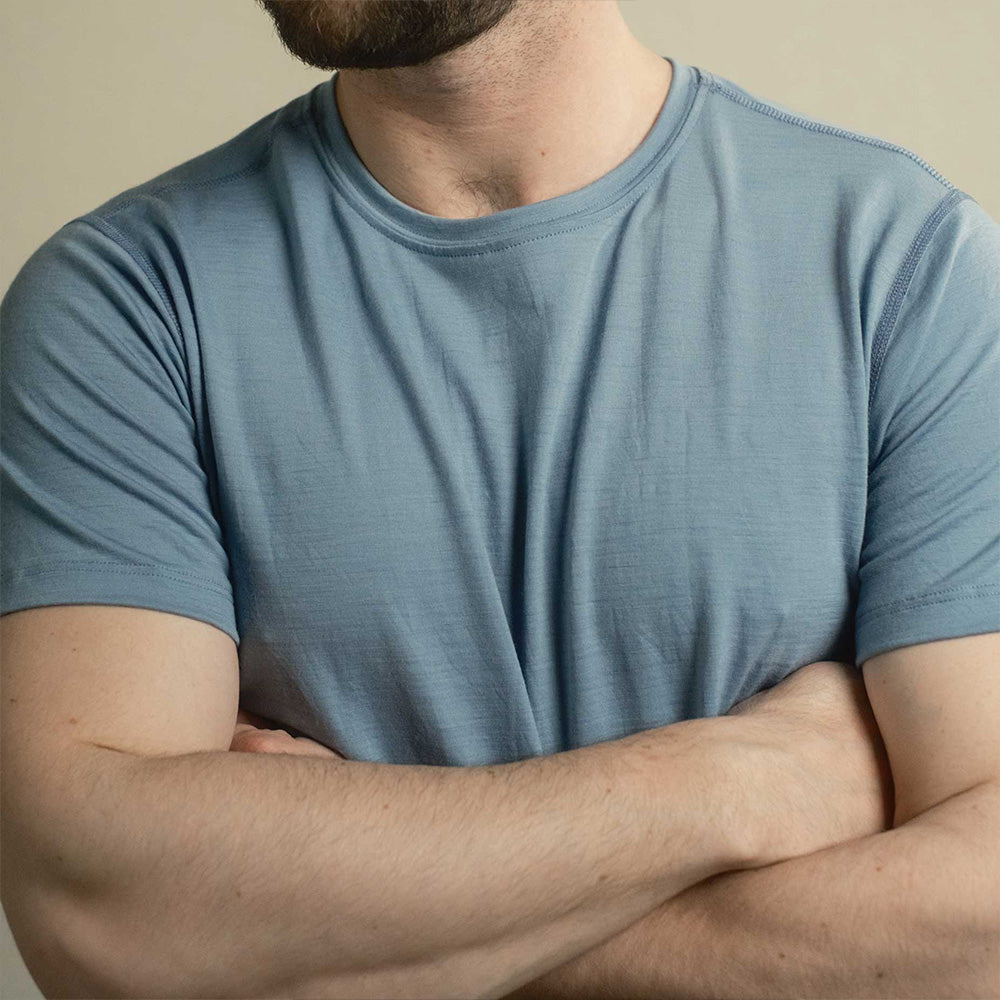 A man wearing a blue American made Duckworth merino wool tee shirt. 