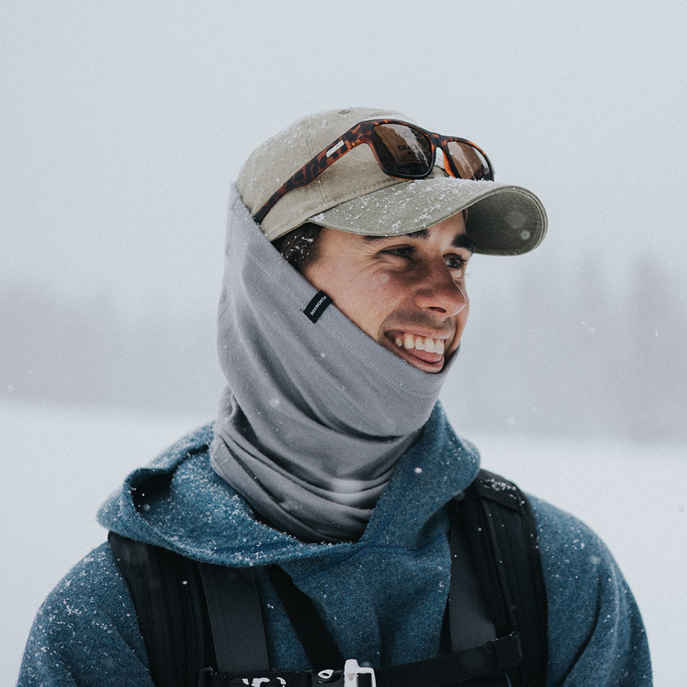 Man smiles in American made Duckworth merino neck gaiter.